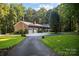 Brick ranch house with a two-car garage and a long paved driveway at 355 Davies Cir, Cleveland, NC 27013