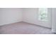 Bright bedroom with carpeted floor and large window at 144 Fleming Dr, Statesville, NC 28677