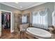 Elegant bathroom with soaking tub, walk-in shower, and large closet at 312 Wintergreen Ct, Kings Mountain, NC 28086