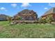 Landscaped backyard with stone retaining walls and patio at 312 Wintergreen Ct, Kings Mountain, NC 28086