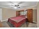 Spacious bedroom with a large bed, ceiling fan, and built-in wooden cabinets at 312 Wintergreen Ct, Kings Mountain, NC 28086