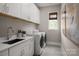 Bright laundry room with white cabinets and modern appliances at 5229 Glenwalk Dr # 0062, Charlotte, NC 28269