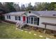 Front view of a ranch home with a red door and bay window at 2852 S Anderson Rd, Catawba, SC 29704