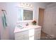 Elegant bathroom with white vanity, decorative mirror, and ample lighting at 312 N Dilling St, Kings Mountain, NC 28086