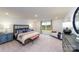 Large main bedroom with a plush bed, window, and stylish decor at 7858 Iron Rd, Sherrills Ford, NC 28673