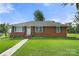 Brick ranch house with a well-maintained lawn and walkway at 117 Bolding St, Gastonia, NC 28052