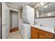 Bathroom with stackable washer and dryer, wood vanity, and tiled floors at 117 Bolding St, Gastonia, NC 28052