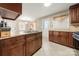 Kitchen with dark wood cabinets, granite countertops, and tile flooring at 117 Bolding St, Gastonia, NC 28052