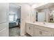 Double vanity bathroom with white cabinets and a large mirror at 208 Wildflower Dr, Locust, NC 28097