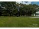 Gravel driveway leading to a charming house nestled in the woods at 3816 Alton St, Huntersville, NC 28078