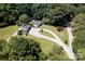 Aerial view of a house on a large lot with a long driveway and surrounding trees at 3816 Alton St, Huntersville, NC 28078