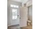 Bright foyer with a powder room and wood-look flooring at 14946 Tamarack Dr, Charlotte, NC 28278