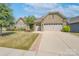 Ranch-style home with stone accents, two-car garage, and a spacious lawn at 3087 Bartlett St, Fort Mill, SC 29715