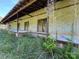 Long, low brick building with overgrown vegetation at 0 Nc Hwy 73 W Hwy, Mount Gilead, NC 27306