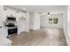 Open concept kitchen and living room with vinyl flooring and stainless steel appliances at 920 Holmes St, Salisbury, NC 28144