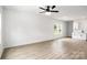 Living room with vinyl plank flooring, ceiling fan, and view to kitchen at 920 Holmes St, Salisbury, NC 28144