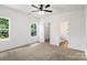 Bright bedroom with carpet, ceiling fan, and access to a private bathroom and closet at 920 Holmes St, Salisbury, NC 28144
