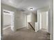 Upstairs hallway with carpet and access to bedrooms at 3309 Paxton Ridge Dr, Indian Trail, NC 28079