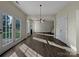 Sunlit dining area with hardwood floors, access to a patio, and a view of the living room at 3309 Paxton Ridge Dr, Indian Trail, NC 28079