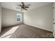 Well-lit bedroom with carpeted floors and a ceiling fan at 3309 Paxton Ridge Dr, Indian Trail, NC 28079