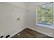 Bright laundry room features built-in shelving and vinyl flooring at 3309 Paxton Ridge Dr, Indian Trail, NC 28079