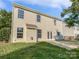Two-story house with light beige siding, a patio, and a grassy backyard at 3309 Paxton Ridge Dr, Indian Trail, NC 28079