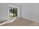 Bright bedroom with large window and neutral carpeting at 3500 Barclay Downs Dr, Charlotte, NC 28209