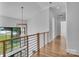 Light-filled hallway with hardwood floors and a stylish chandelier at 3500 Barclay Downs Dr, Charlotte, NC 28209