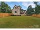 Spacious backyard with grassy lawn and privacy fence at 3500 Barclay Downs Dr, Charlotte, NC 28209
