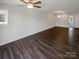 Open living room with hardwood floors, high ceilings and large windows at 4432 Eaves Ln, Charlotte, NC 28215