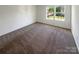 Well-lit bedroom with neutral carpeting and large windows at 4432 Eaves Ln, Charlotte, NC 28215