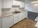 White kitchen cabinets, double sink and dishwasher at 4432 Eaves Ln, Charlotte, NC 28215