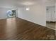 Open living room with hardwood floors and access to balcony and entry at 4432 Eaves Ln, Charlotte, NC 28215