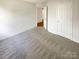 Bright bedroom with gray carpet and access to hallway at 4432 Eaves Ln, Charlotte, NC 28215