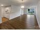 Spacious living room featuring hardwood floors and access to balcony at 4432 Eaves Ln, Charlotte, NC 28215