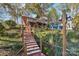 Brick home with stairs leading to a deck and lake views at 151 River Ridge Ln, Statesville, NC 28677