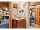 Small bathroom with wood vanity, mirror, and built in shelving at 151 River Ridge Ln, Statesville, NC 28677