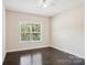 Bright bedroom with dark hardwood floors and a large window at 531 Tributary Dr # 26, Fort Lawn, SC 29714