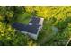 Aerial view of a unique L-shaped house nestled in a wooded area at 9224 Maggie Robinson Rd, Waxhaw, NC 28173