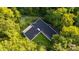 Aerial view of a modern home surrounded by trees at 9224 Maggie Robinson Rd, Waxhaw, NC 28173