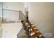 View of a modern interior staircase with metal railings at 9224 Maggie Robinson Rd, Waxhaw, NC 28173