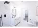 Modern bathroom with white cabinets, marble tile shower, and black fixtures at 615 English St, Monroe, NC 28110