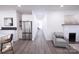 Bright hallway with stainless steel refrigerator and gray chair at 615 English St, Monroe, NC 28110