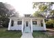 Front view of a charming white house with a porch at 615 English St, Monroe, NC 28110