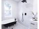 Spa-like bathroom with a freestanding tub, walk-in shower, and marble tile at 615 English St, Monroe, NC 28110
