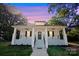 White house with a front porch and landscaped yard at 615 English St, Monroe, NC 28110