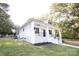 White house with a wrap around porch at 615 English St, Monroe, NC 28110