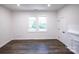Spacious bedroom with hardwood floors and two windows at 615 English St, Monroe, NC 28110