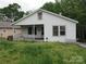 White house with a porch, situated on a grassy lot at 1146 Buffalo St, Shelby, NC 28150