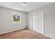 Simple bedroom with carpet, double closet, and window at 145 Jim Barnes Ln, Taylorsville, NC 28681